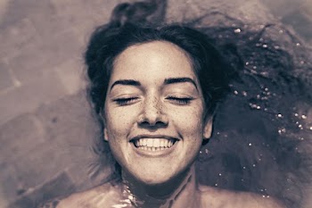 woman smiling while bathing