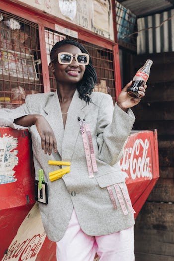 Woman Smiling While Holding Bottle of Coca-cola