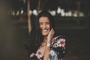 Woman Smiling While Touching Her Hair
