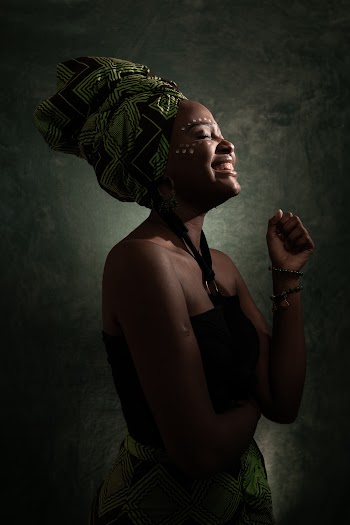Woman Smiling While Wearing Green Headwear