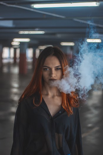 Woman Smoking on Parking Space