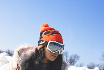 Woman Snowboarding Beside Leafless Trees