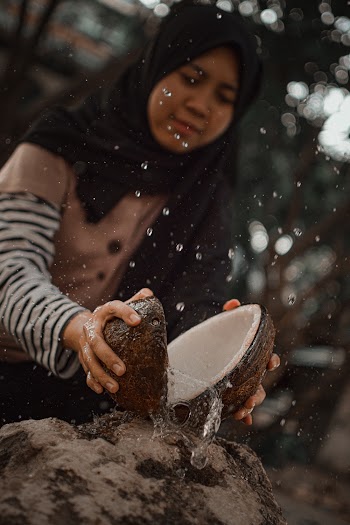 Woman Splitting Coconut Husk