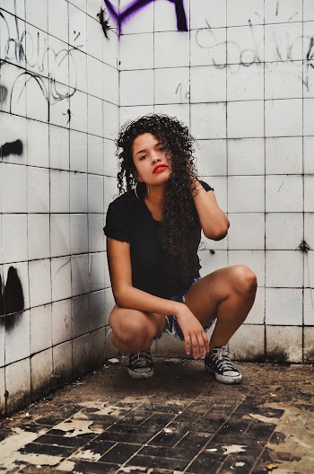 Woman Squatting Near Tile
