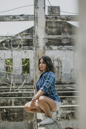 Woman Squatting on Concrete Surface