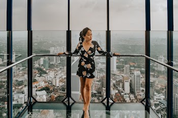Woman Standing Against Railing