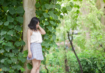 Woman Standing Against Tree