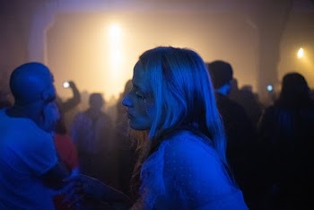 Woman Standing Among The Crowd