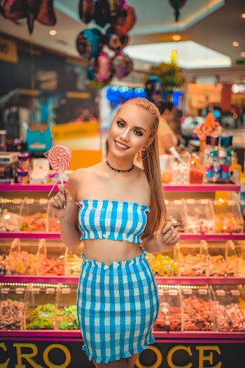 Woman Standing and Holding A Candy