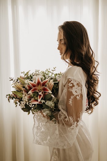 Woman Standing and Holding Flowers