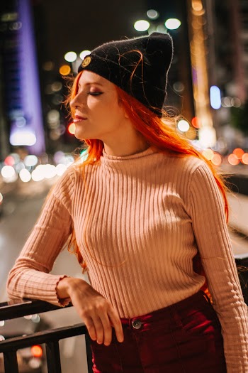 Woman Standing and Holding on Railings