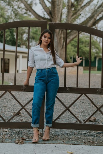 Woman Standing And Leaning On Gate