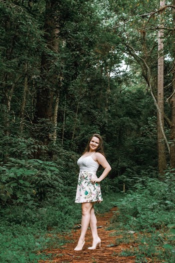 Woman Standing and Posing Under Green Trees