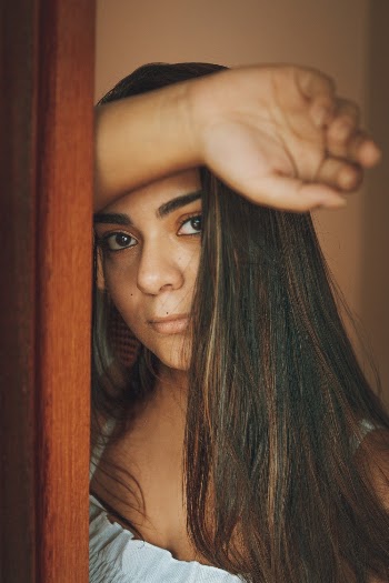 Woman Standing and Putting Right Hand on Her Forehead