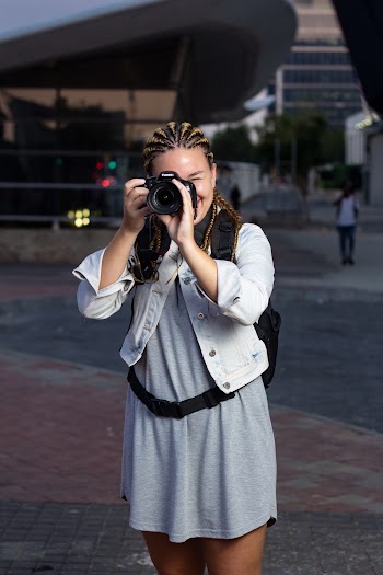 Woman Standing And Using Dslr Camera