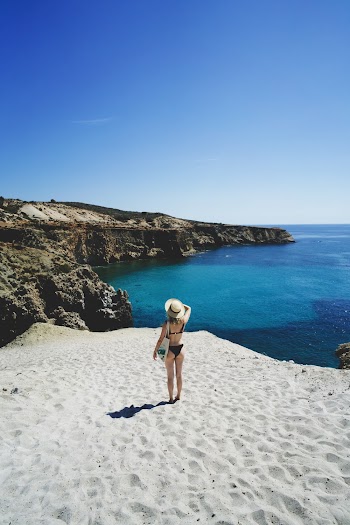 Woman Standing at a Sandy Cliff
