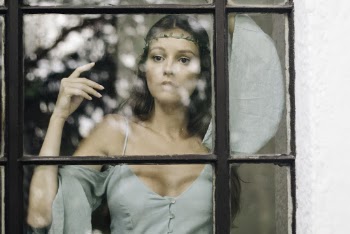 Woman Standing Behind Glass Window