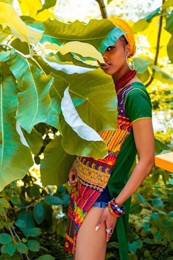 Woman Standing Behind Green Leaves