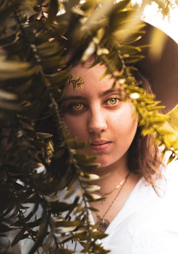 Woman Standing Behind Plant