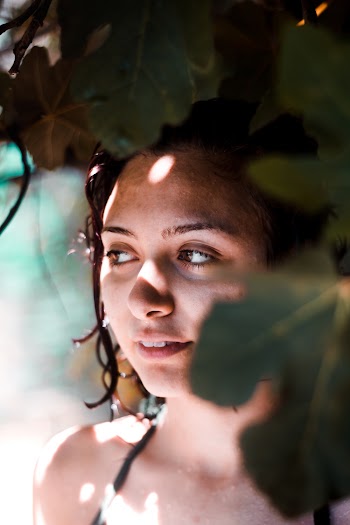 Woman Standing Behind Plants