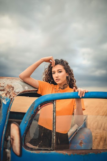 Woman Standing Behind The Door Of An Old Car
