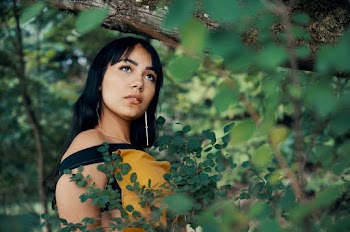 Woman Standing Behind Trees