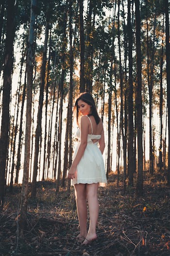 Woman Standing Behind Trees