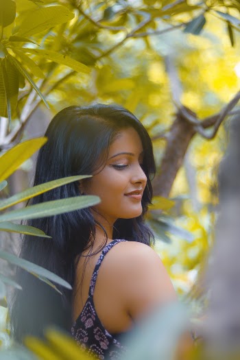Woman Standing Behind Trees