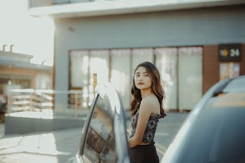Woman Standing Beside a Car
