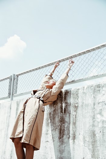 Woman Standing Beside a wall  