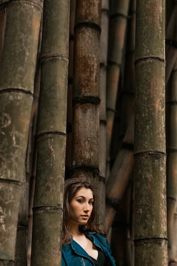 Woman Standing Beside Bamboo