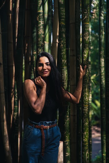 Woman Standing Beside Bamboo Trees