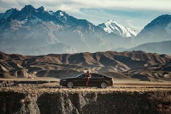 Woman Standing Beside Black Car