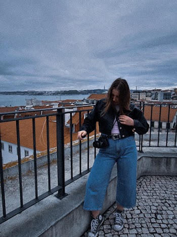 Woman Standing Beside Black Metal Railing