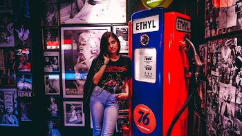 Woman Standing Beside Blue And Red Gas Pump