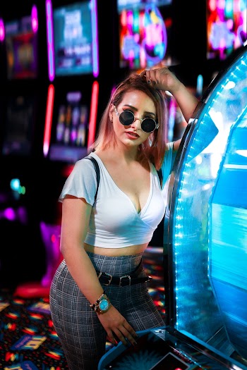 Woman Standing Beside Blue Led Machine