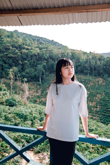 Woman Standing Beside Blue Metal Rail