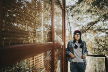 Woman Standing Beside Brown Full-lite Panel Door