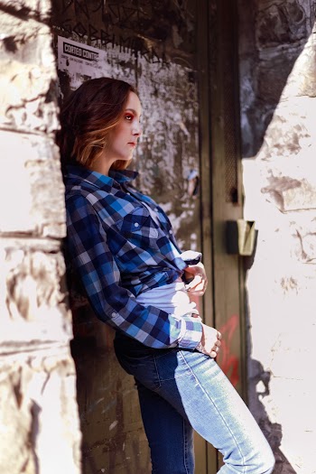 Woman Standing Beside Brown Wooden Door