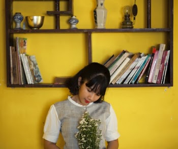 Woman Standing Beside Brown Wooden Shelf