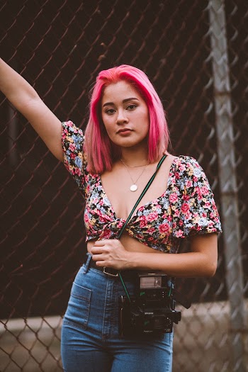Woman Standing Beside Chainlink Fence