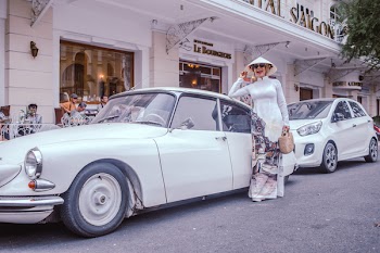 Woman Standing Beside Classic White Sedan