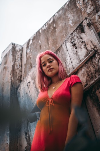 Woman Standing Beside Concrete Wall