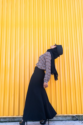 Woman Standing Beside Corrugated Sheet Wall