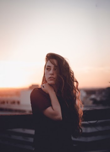 Woman Standing Beside Fence