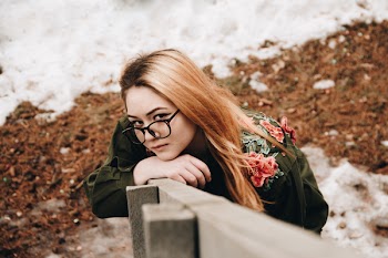 Woman Standing Beside Fence