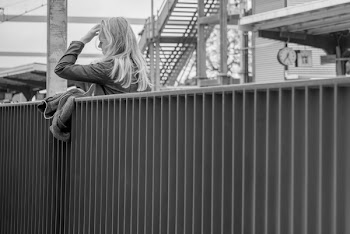 Woman Standing Beside Fence