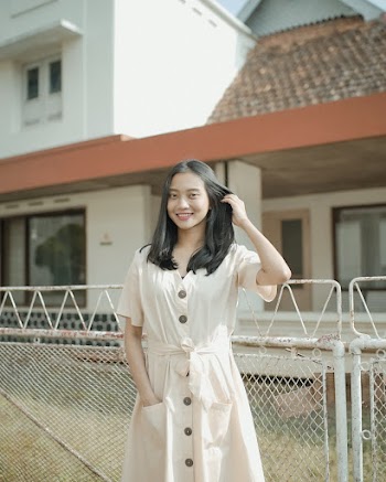 Woman Standing Beside Fence