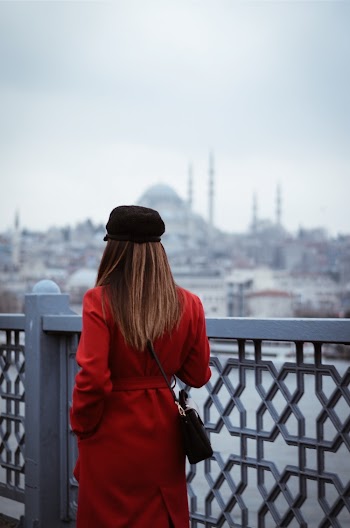 Woman Standing Beside Fence