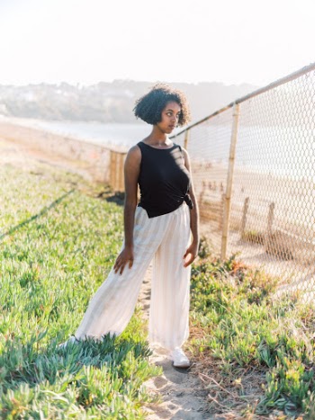 Woman Standing Beside Fence